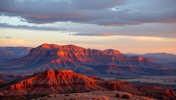 a plateau of red rock glowing in the golden light of a late afternoon sun. photo