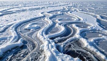 a frozen lake where wind has sculpted the snow into intricate, wave like patterns. photo