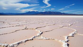 a glowing salt flat stretching endlessly beneath a sapphire blue sky. photo