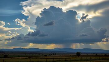 a thundercloud forming above distant hills, casting deep shadows across the plains. photo