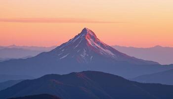 a lone mountain peak piercing through layers of pink and orange dawn light. photo