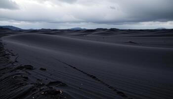 a vast plain of black sand beneath a storm darkened sky. photo