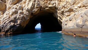 a sea cave entrance partially submerged, echoing with distant waves. photo