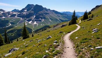 a peaceful mountain trail winding through alpine meadows and past rocky outcrops dusted with snow. photo