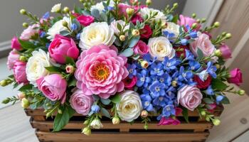 a large wooden crate overflowing with fresh cut peonies, eucalyptus, and delphiniums photo