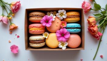 a box of colorful macarons paired with matching real flowers photo