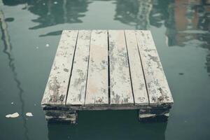 An old wooden plank sits in the water photo