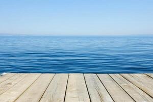 Wooden dock over the sea with blue sky background photo