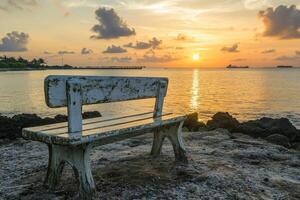 A bench sitting on the beach photo