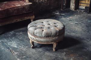 A round ottoman sitting on a concrete floor photo