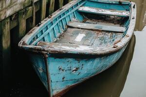 A blue boat is docked in the water photo