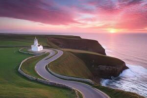 A lighthouse on a cliff overlooking the ocean at sunset photo