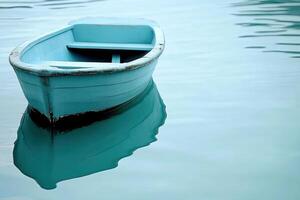 A small blue boat floating in the water photo