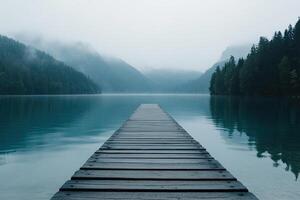 A long wooden pier leads into a lake photo