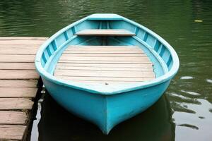A small boat is tied to a dock photo