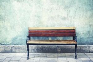 A wooden bench sitting against a wall photo