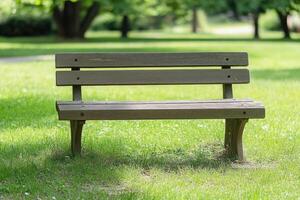 A wooden bench sitting in a grassy field photo