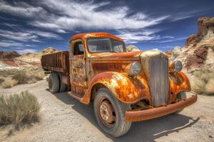 An old rusty truck is parked in the desert photo