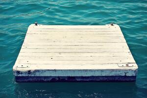 A wooden floating dock in the water photo