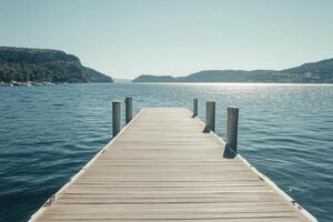 A wooden dock extends into the water photo