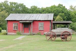 Rustic red farmhouse with antique wagon photo