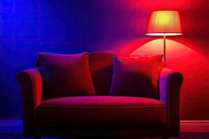 Red couch with pillows in a room with red and blue lighting photo