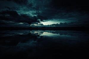 Dark, Stormy Landscape Reflecting on Water photo