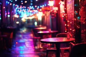 A dark alley with tables and chairs under colorful lights photo