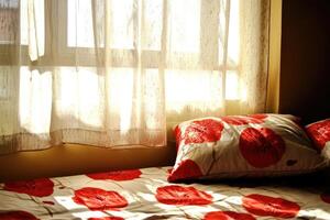 A bed with a red and white floral pattern photo