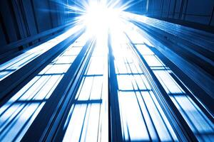 A blue light shines through the windows of a building photo