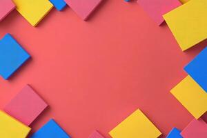 Colorful paper squares on a red background photo