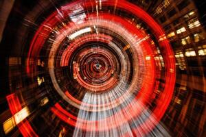 A blurry image of a red light in a city photo