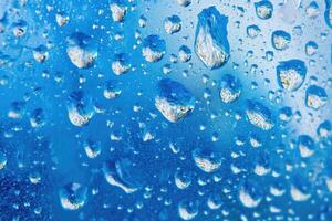 Water droplets on a blue window photo