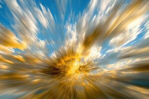 A blurry image of a sunburst with clouds photo