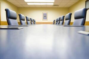 A conference room with blue chairs and a table photo