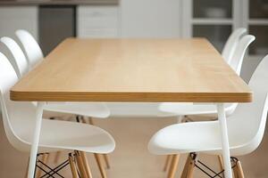 A wooden table with white chairs in a kitchen photo