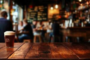 A glass of beer sitting on a wooden table photo