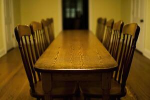 A long wooden table with six chairs photo