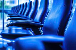 A row of blue chairs in an office building photo