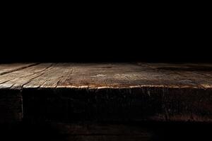 An old wooden table with a dark background photo