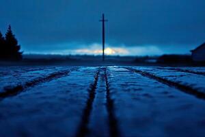 A cross is seen in the distance at night photo