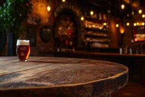 A wooden table with a glass of beer on it photo