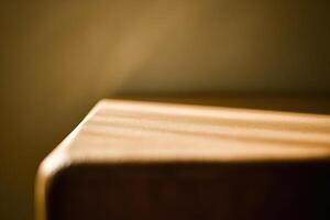 A close up of a wooden table with a light shining on it photo