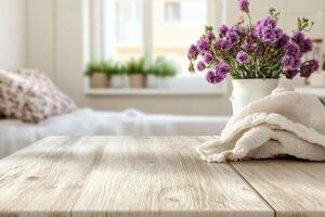 A wooden table with a vase of flowers on it photo
