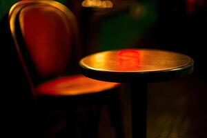 A table and chair in a dark room photo