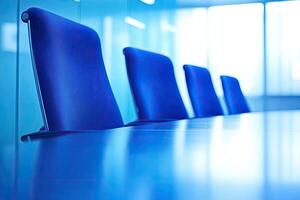 A row of blue chairs in a conference room photo