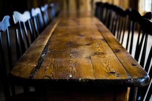 A long wooden table with black chairs photo