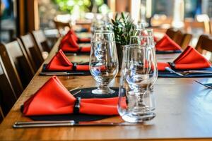 A table with red napkins and glasses photo