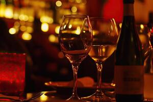 A table with two wine glasses and a bottle of wine photo