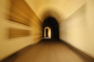 A blurry image of a tunnel with a light in the middle photo